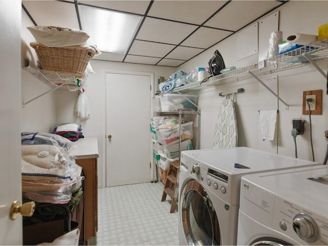 washroom with washer and dryer, laundry area, and light floors