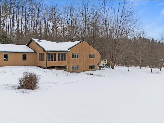 view of snow covered back of property