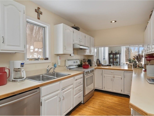 kitchen featuring range with electric cooktop, under cabinet range hood, dishwasher, white cabinets, and a sink