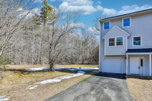 view of property exterior featuring driveway and a garage