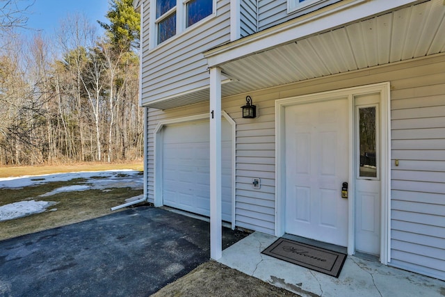 entrance to property featuring aphalt driveway