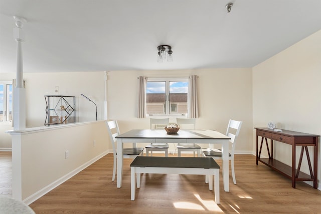 dining area with baseboards and light wood finished floors