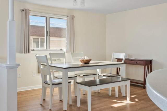 dining space with wood finished floors and baseboards