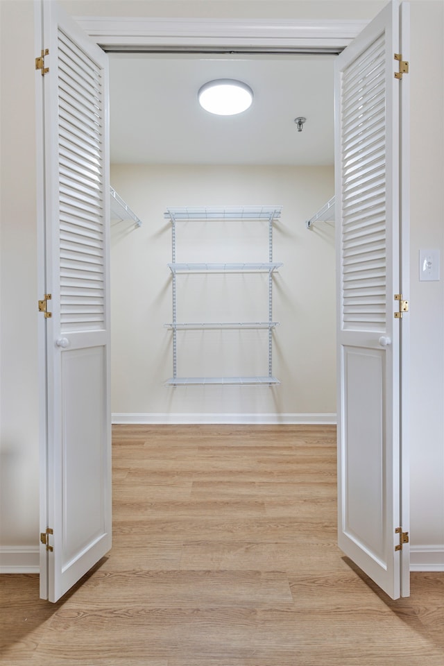 spacious closet featuring wood finished floors