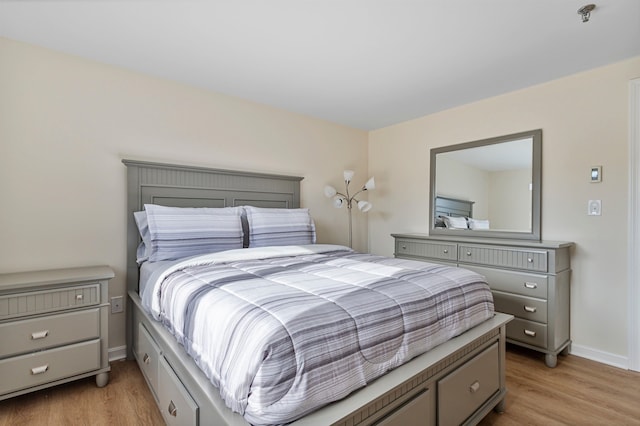 bedroom featuring baseboards and light wood-style floors