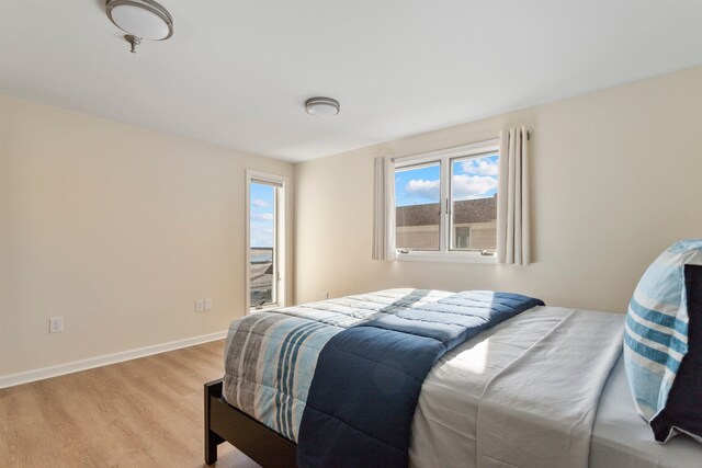 bedroom with light wood-style flooring and baseboards