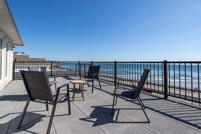 view of patio with a water view