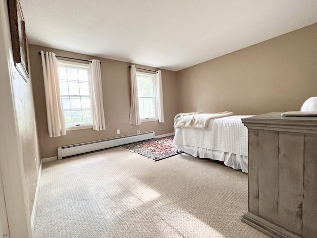 bedroom with carpet, baseboards, and a baseboard radiator