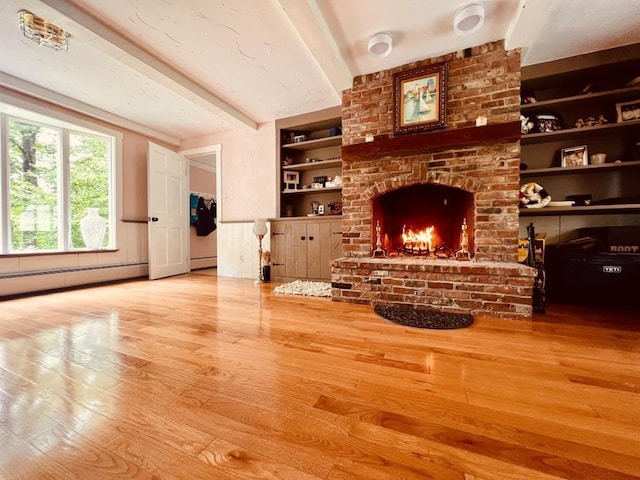 unfurnished living room featuring beam ceiling, a brick fireplace, built in features, and wood finished floors