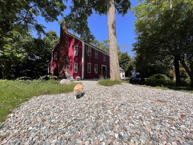 view of front of house featuring a chimney