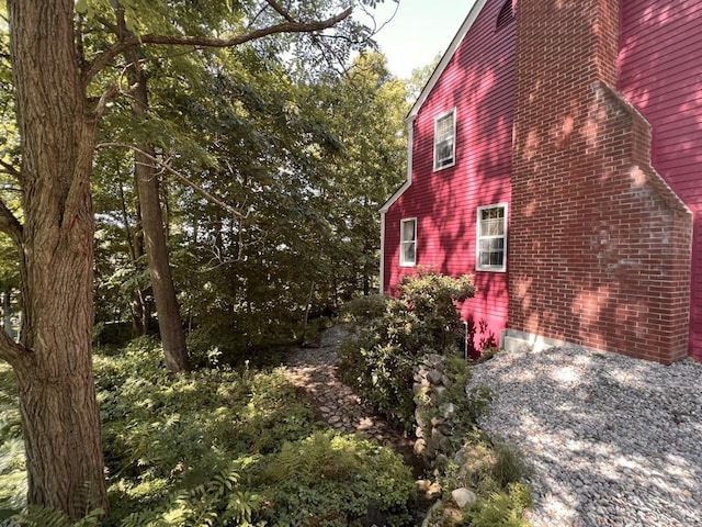 view of side of property featuring brick siding