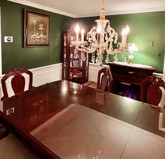 dining room with ornamental molding and wainscoting