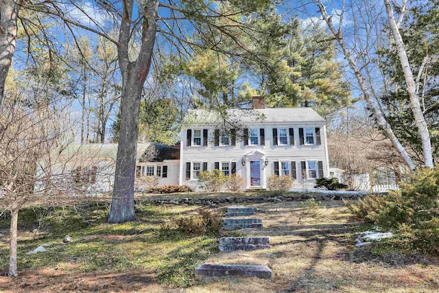 colonial inspired home with a chimney