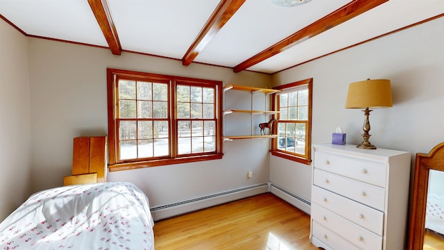 bedroom with beamed ceiling, light wood finished floors, and a baseboard radiator