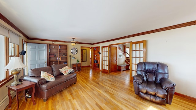 living room with light wood finished floors, french doors, a wealth of natural light, and a baseboard radiator