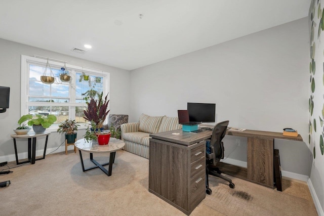 office area featuring visible vents, baseboards, and light colored carpet