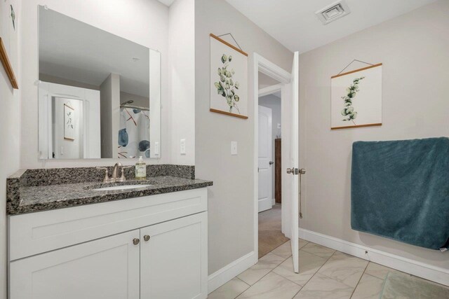 bathroom featuring visible vents, marble finish floor, vanity, and baseboards