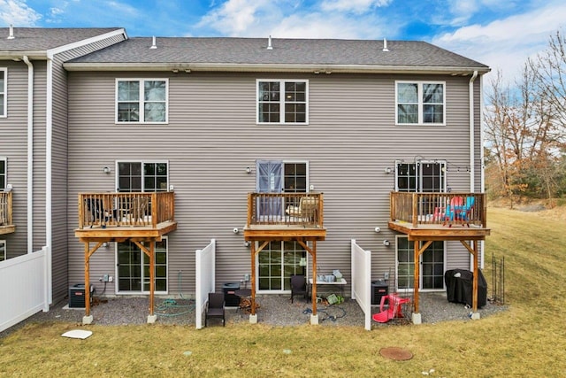 back of property featuring a yard, a patio area, and fence