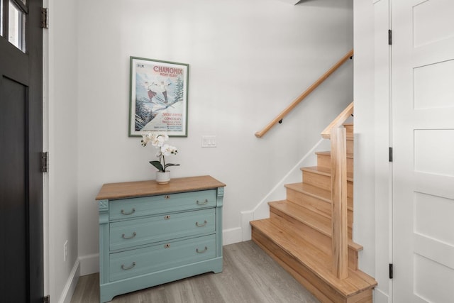 stairs featuring baseboards and wood finished floors