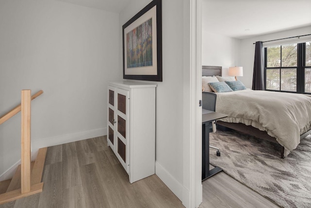 bedroom with wood finished floors and baseboards