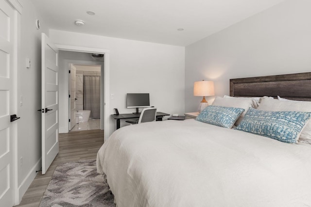 bedroom with light wood-type flooring and baseboards