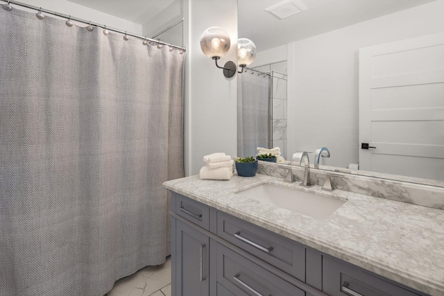 full bathroom with marble finish floor and vanity