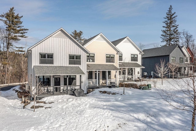 view of front of home featuring board and batten siding, covered porch, and roof with shingles