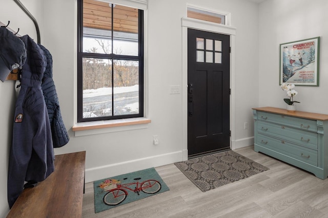 foyer entrance featuring baseboards and light wood finished floors