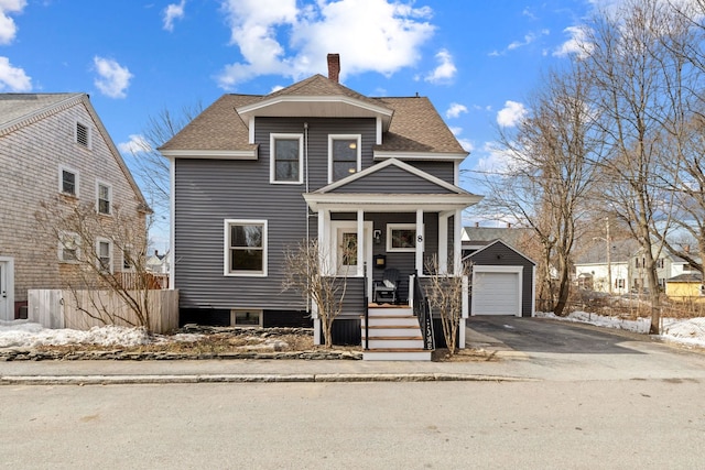 view of front of property featuring driveway, a porch, fence, an outdoor structure, and a shingled roof