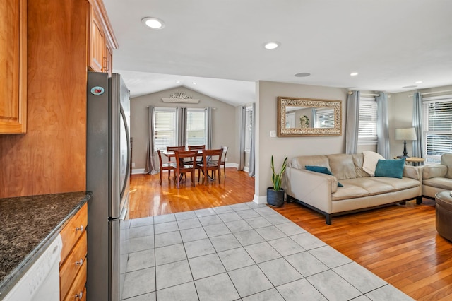 living room with recessed lighting, baseboards, lofted ceiling, and light wood-style floors