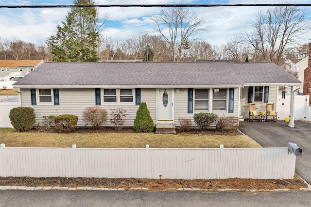 single story home with a front lawn, entry steps, a fenced front yard, aphalt driveway, and roof with shingles