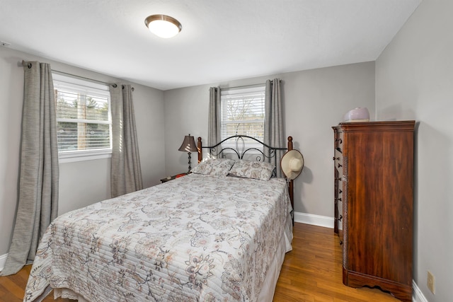 bedroom featuring wood finished floors and baseboards