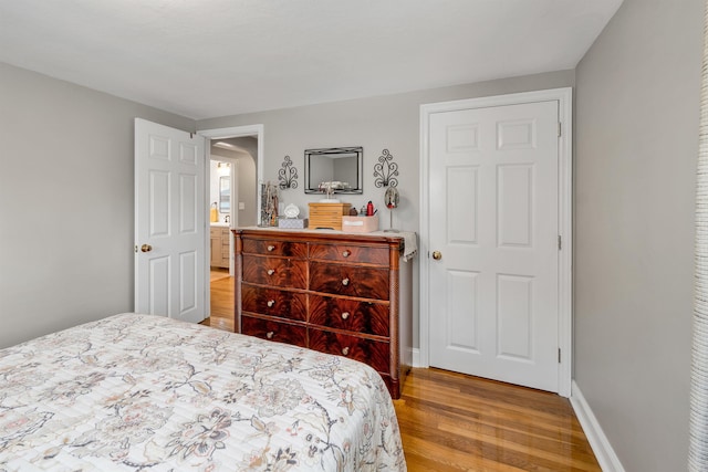 bedroom featuring light wood-style floors and baseboards