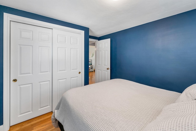 bedroom featuring light wood finished floors and a closet