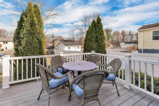 wooden deck with a residential view, outdoor dining area, and fence