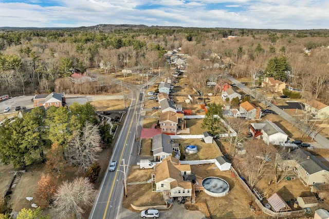 birds eye view of property featuring a forest view