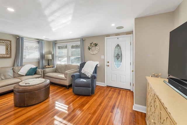 living area with recessed lighting, light wood-type flooring, and baseboards