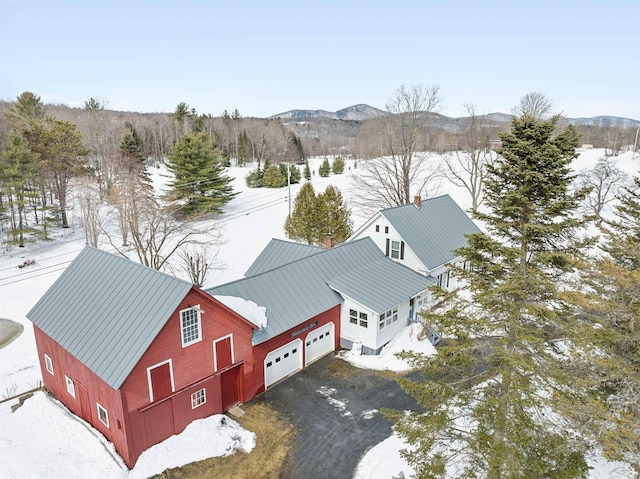 snowy aerial view featuring a mountain view