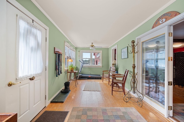 entrance foyer with crown molding, light wood-style floors, baseboards, and ceiling fan