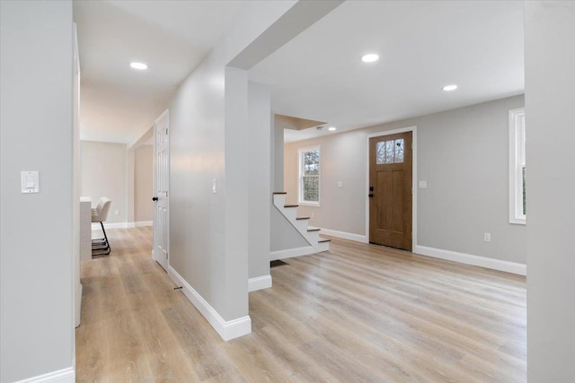 foyer entrance featuring recessed lighting, baseboards, and light wood-style floors