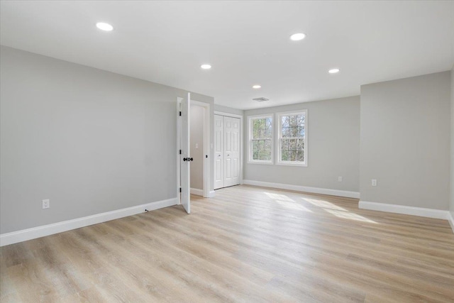 interior space featuring recessed lighting, light wood-type flooring, baseboards, and visible vents