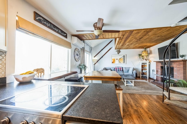 kitchen with a ceiling fan, wood finished floors, wood ceiling, a wall mounted air conditioner, and range