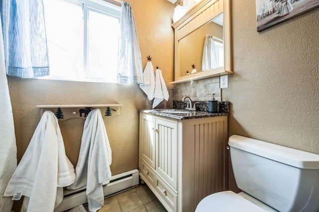 bathroom featuring tile patterned floors, toilet, and a textured wall