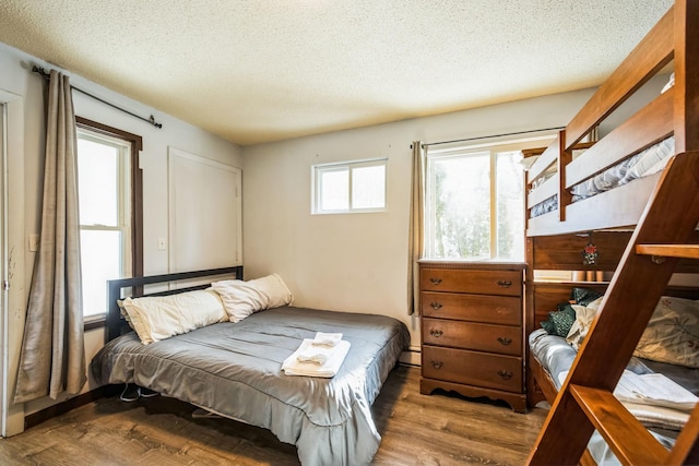 bedroom featuring a textured ceiling and wood finished floors