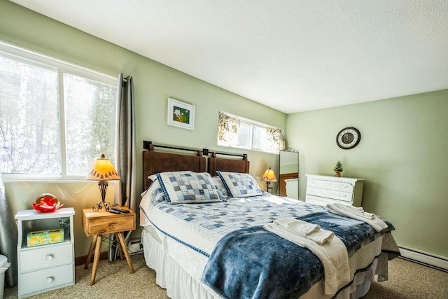 bedroom with carpet, baseboards, and a baseboard radiator