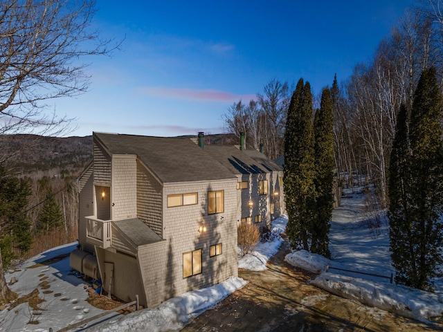 exterior space featuring a shingled roof