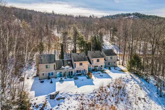 snowy aerial view featuring a view of trees