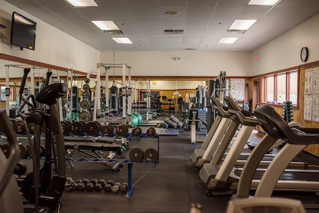 workout area featuring visible vents and a paneled ceiling