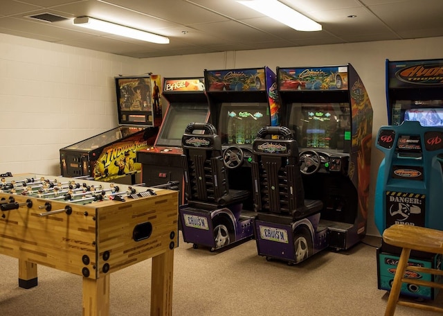 playroom featuring concrete block wall and carpet floors