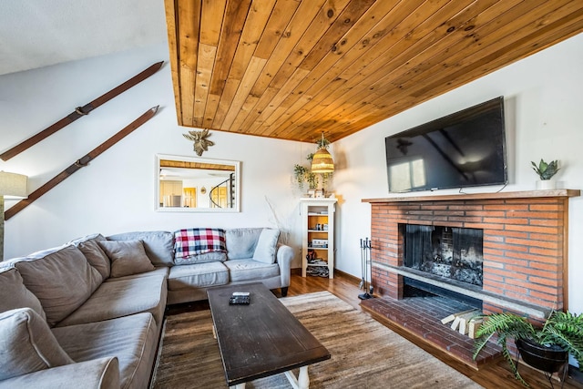 living area featuring wood finished floors, wood ceiling, a fireplace, and lofted ceiling